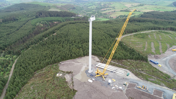 Aerial video of crane at construction project in North Wales